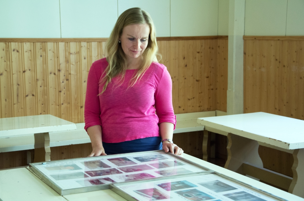Kyläseuran puheenjohtaja Sanna Mäkinen tutki pöydille koottua valokuvanäyttelyä, joka kertoo kyläseuran historiasta.