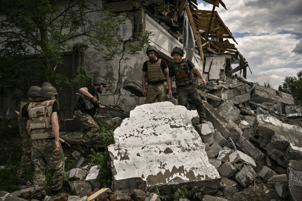 Ukrainalaissotilaat tarkastivat tuhoutunutta varastorakennusta Lysytshanskin liepeillä. LEHTIKUVA / AFP 