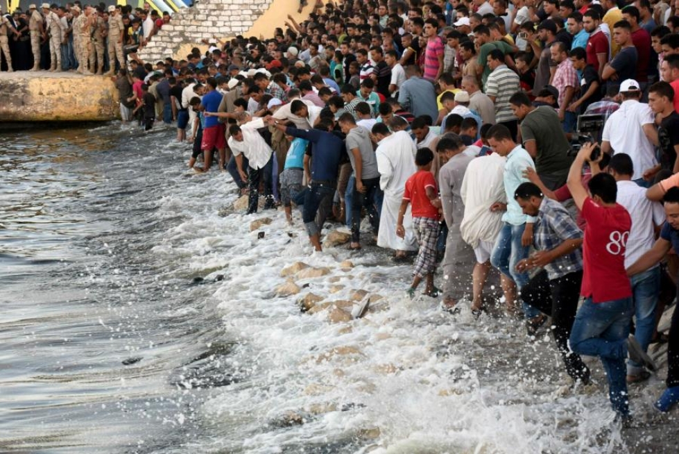 Ihmisiä kokoontui Rosettan satamakaupungin rannalle odottamaan pakolaisten ruumiiden tuomista maihin. LEHTIKUVA/AFP