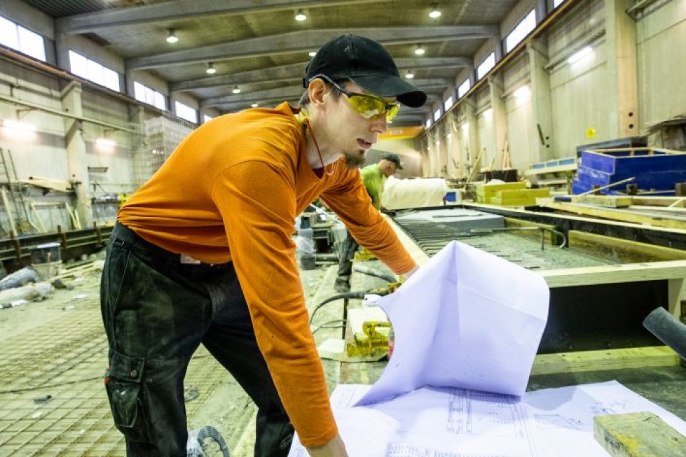 Liippaaminen eli valettujen elementtien pinnan tasoittaminen on Antti Toivasen mielestä helppo tapa aloittaa betonialan työt. Papereista selviää, että parhaillaan työstettävä pumppaamon pohjalaatta painaa lähes kolme ja puoli tonnia.