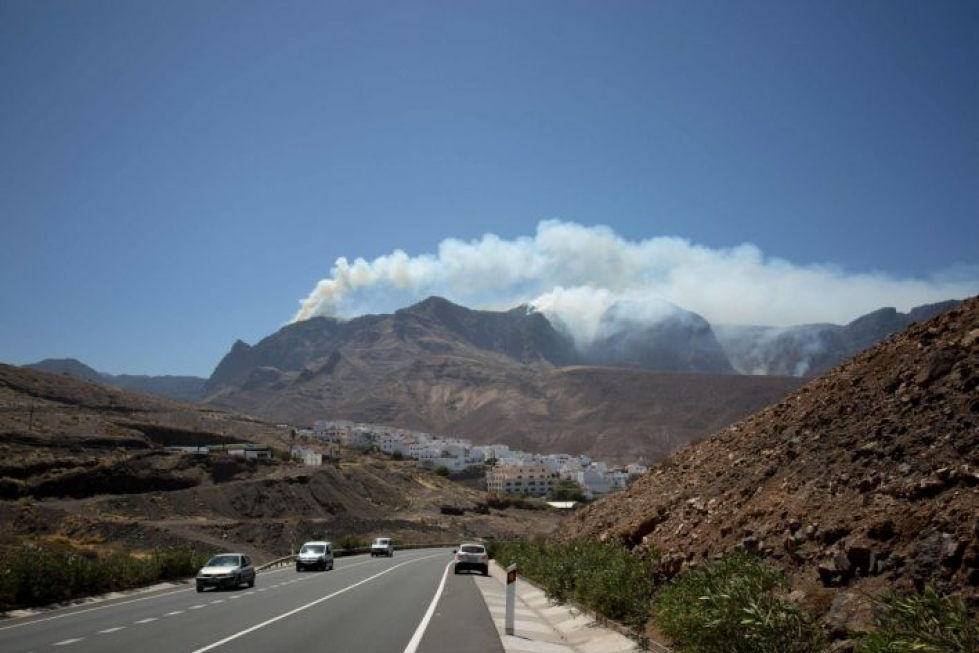 Palo on toistaiseksi ehtinyt tuhota 12 000 hehtaaria maata. LEHTIKUVA/AFP