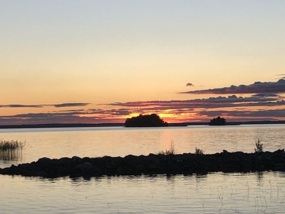 Iltaaurinko laskee horisontin taakse Pyhäselän rannassa 27. elokuuta.