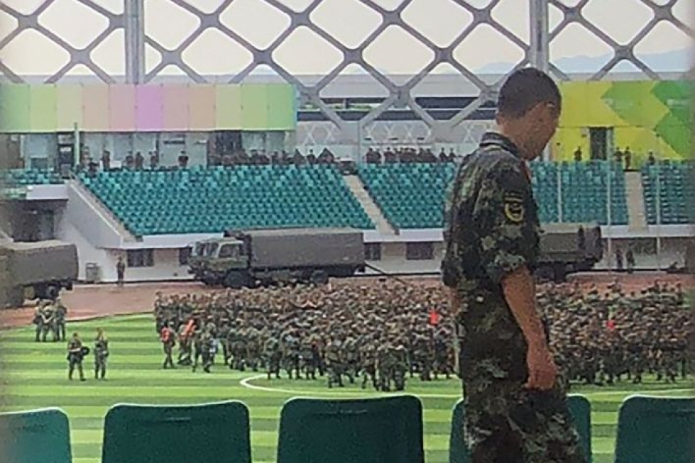 Shenzhenin kaupungin urheilustadionille oli torstaina kokoontunut Kiinan lippua heiluttavia maastoasuun pukeutuneita poliiseja. LEHTIKUVA/AFP