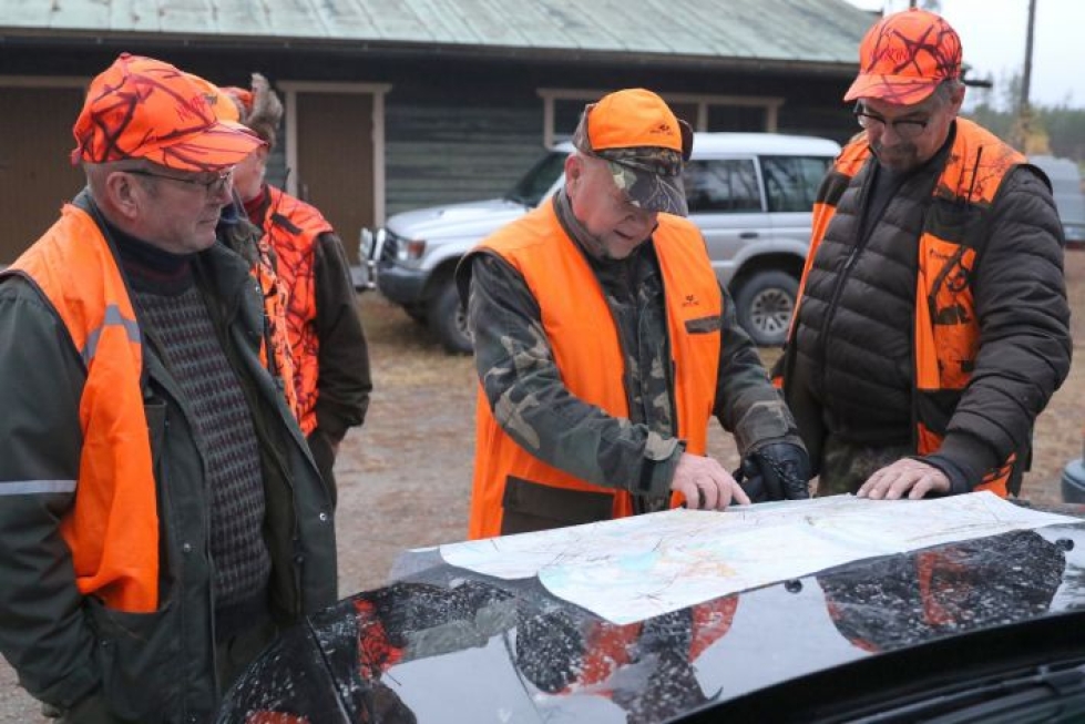 Hirviporukan johtaja Jorma Hirvonen näyttää kartasta, mihin osaan maita metsästys kohdistuu.